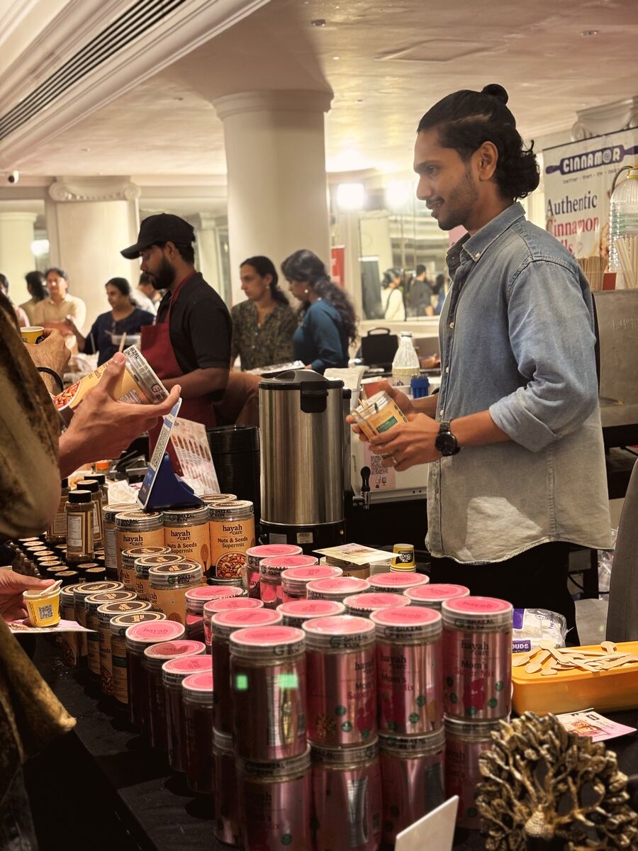 A vendor pouring a taster at the jar stall