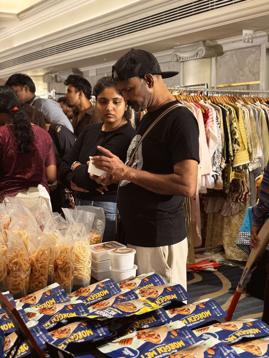 Shoppers picking out snacks at a crowded stall